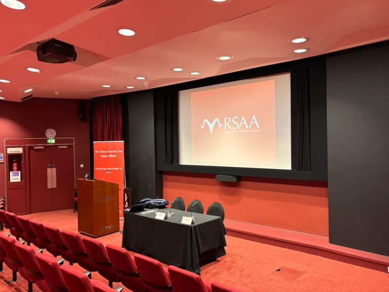 An auditorium with an RSAA banner and projected logo